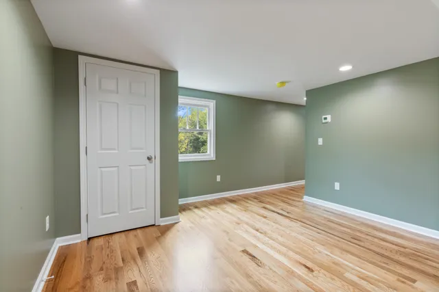 a front view of a house with a yard and trees