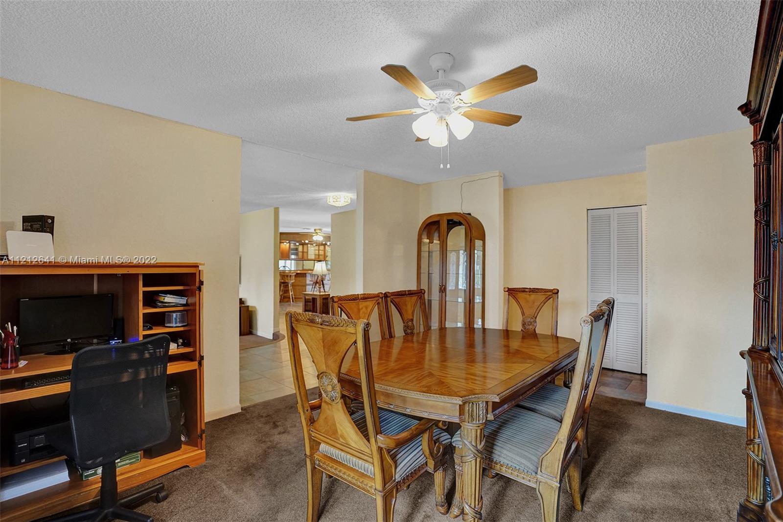 7420 Southwest 15th Street Plantation, FL 33317 - Photo 14 of 60 a view of a dining room with furniture and a chandelier