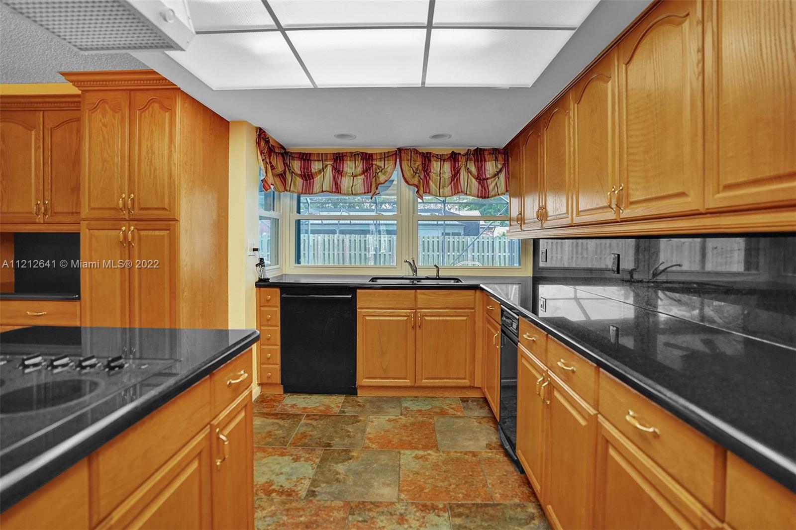 7420 Southwest 15th Street Plantation, FL 33317 - Photo 15 of 60 a kitchen with stainless steel appliances granite countertop a sink stove and refrigerator