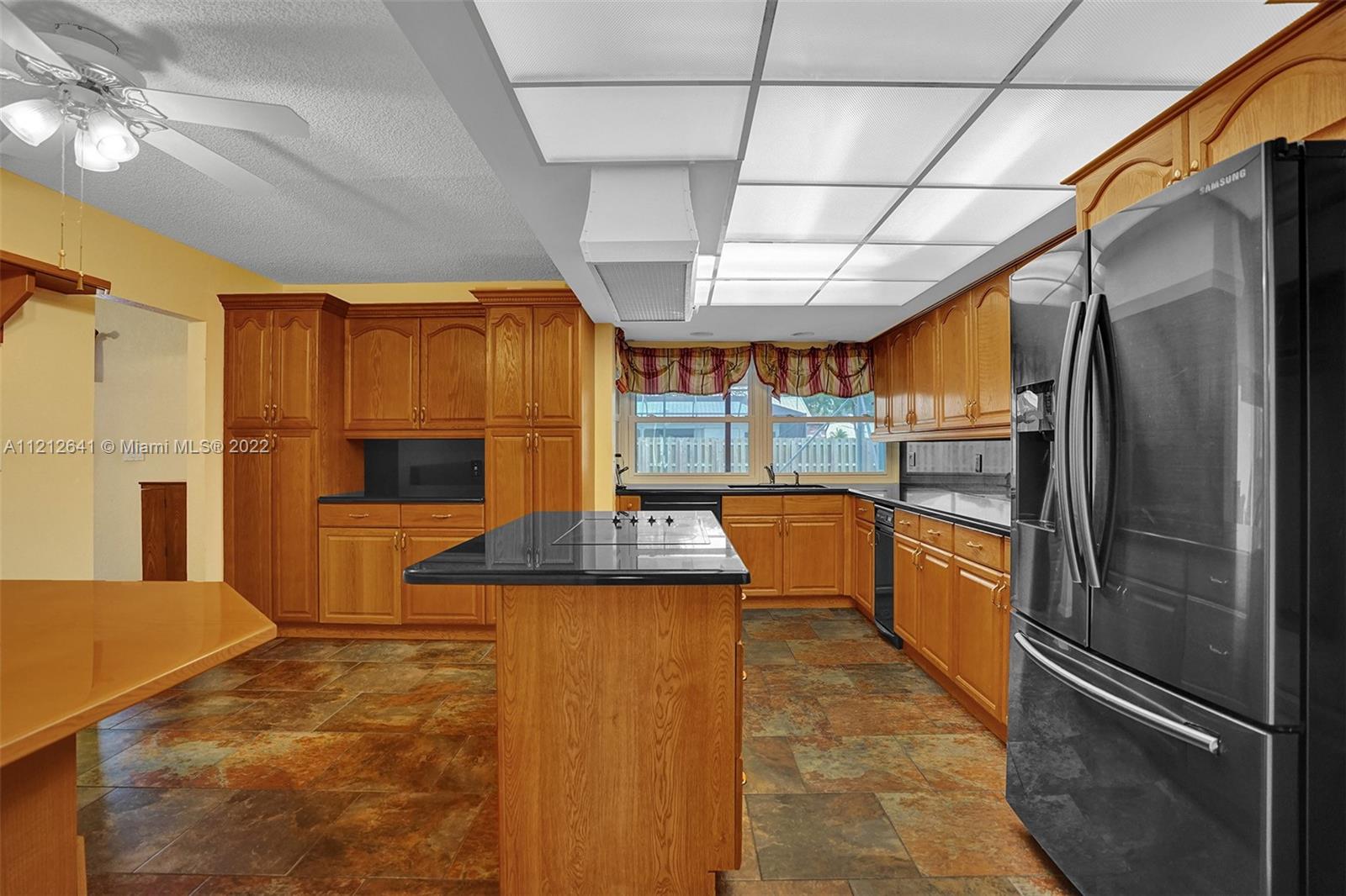 7420 Southwest 15th Street Plantation, FL 33317 - Photo 16 of 60 a kitchen with stainless steel appliances granite countertop a refrigerator and a stove