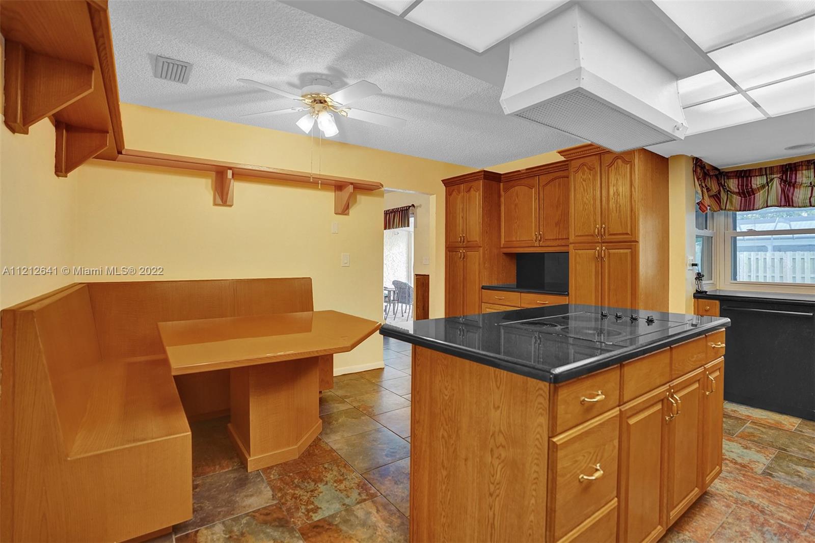 7420 Southwest 15th Street Plantation, FL 33317 - Photo 17 of 60 a kitchen with stainless steel appliances granite countertop a stove a sink dishwasher and a refrigerator with wooden floor