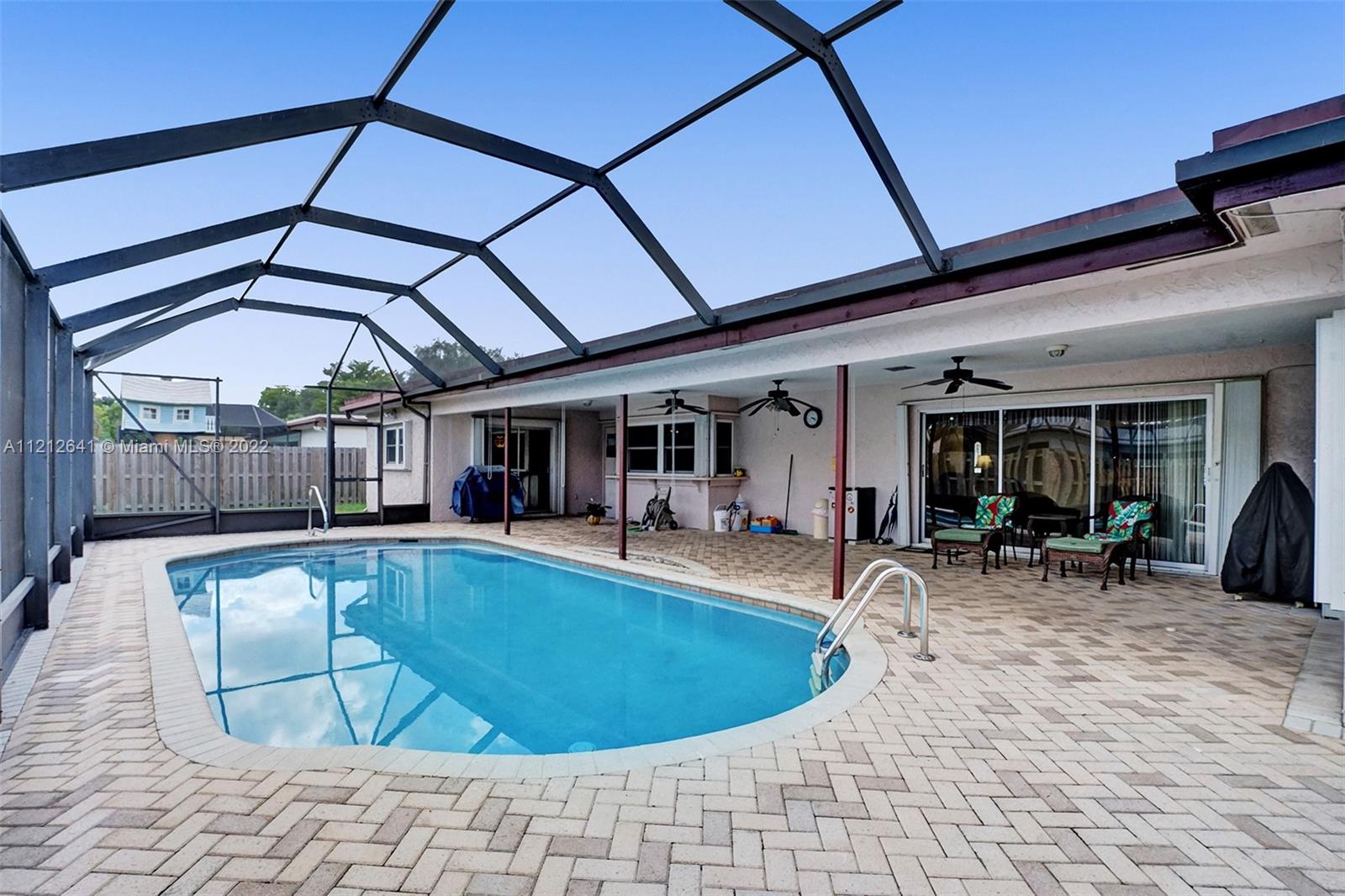 7420 Southwest 15th Street Plantation, FL 33317 - Photo 2 of 60 a view of a swimming pool with sitting area