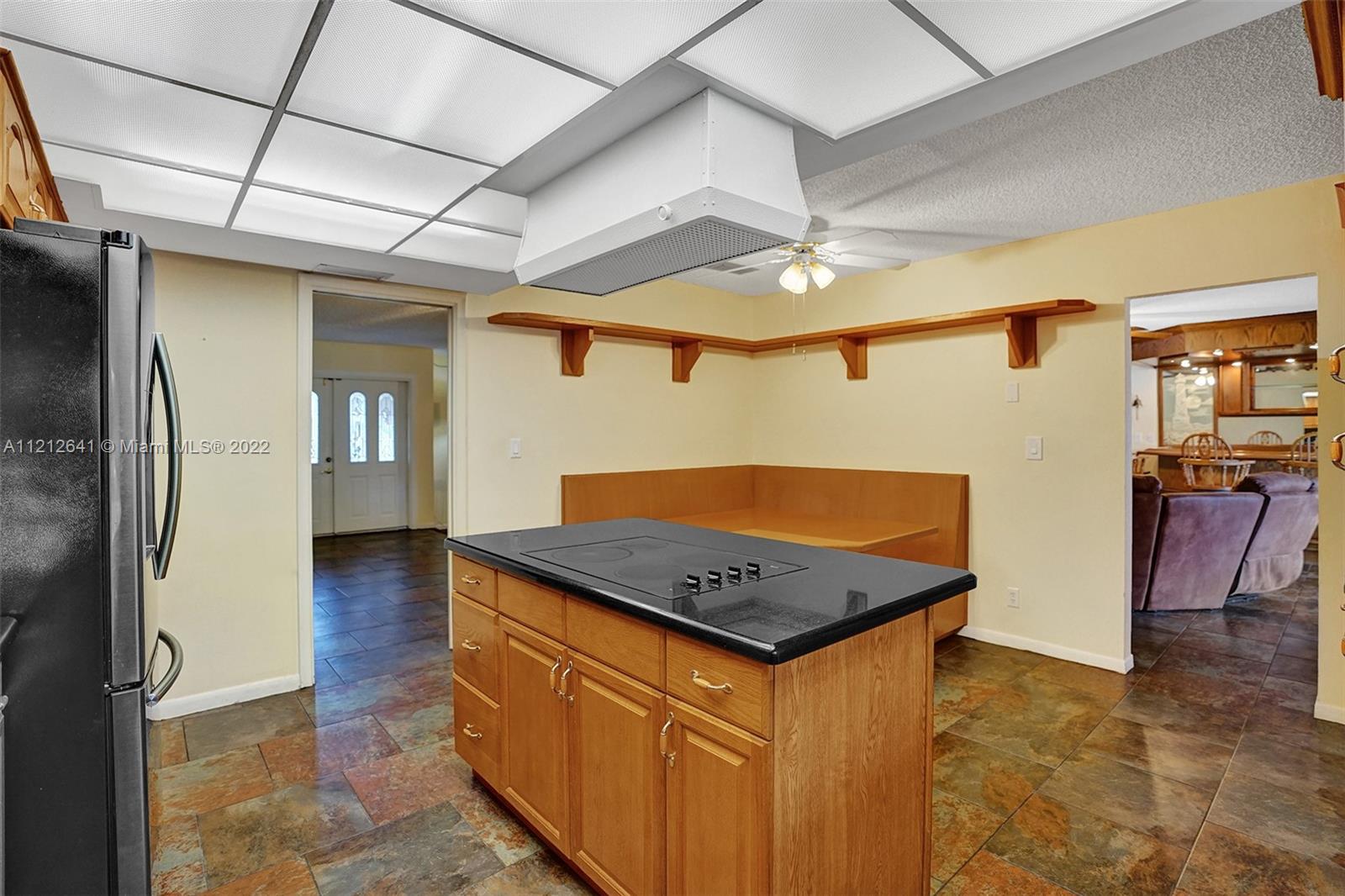 7420 Southwest 15th Street Plantation, FL 33317 - Photo 22 of 60 a view of a hallway with a dining table and chairs