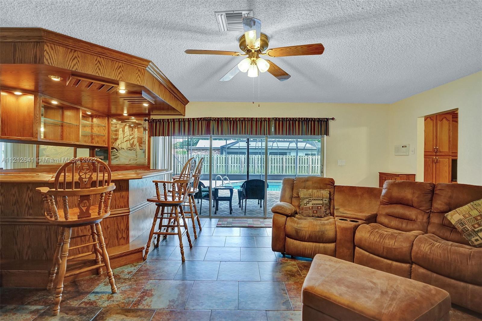 7420 Southwest 15th Street Plantation, FL 33317 - Photo 24 of 60 a living room with furniture a chandelier and a large window