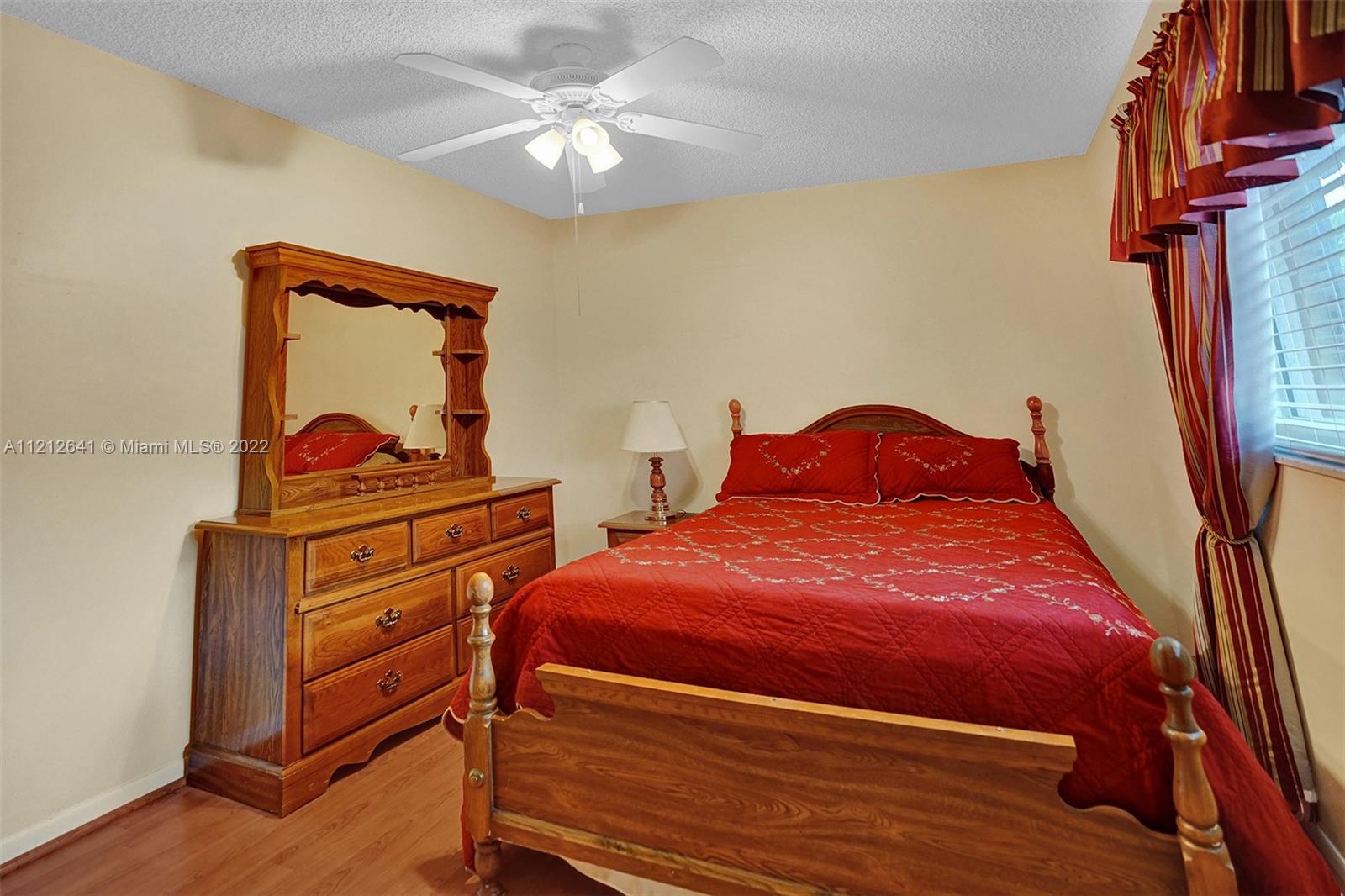 7420 Southwest 15th Street Plantation, FL 33317 - Photo 30 of 60 a bedroom with two beds and a chandelier