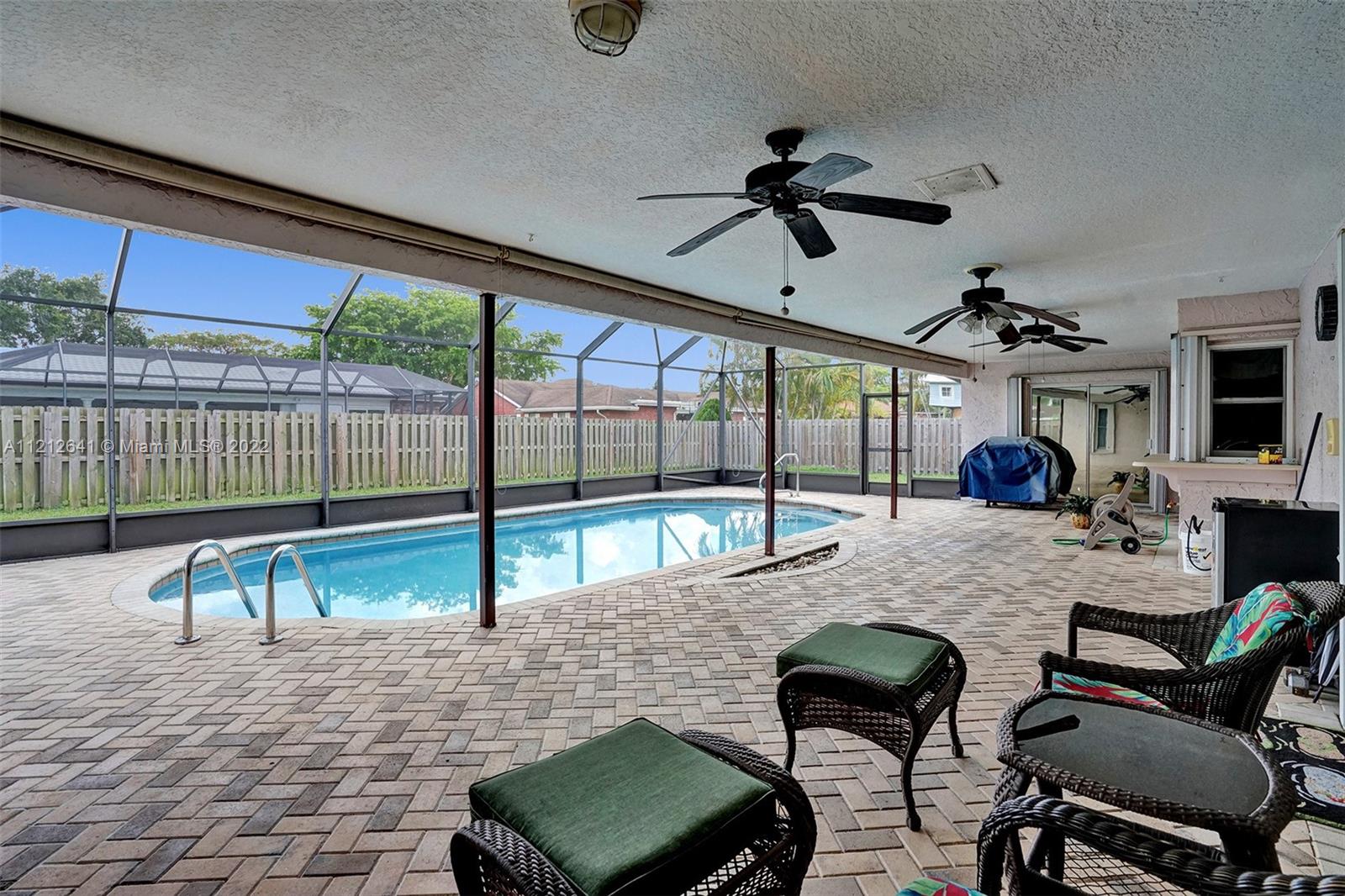 7420 Southwest 15th Street Plantation, FL 33317 - Photo 3 of 60 a living room with furniture and a floor to ceiling window