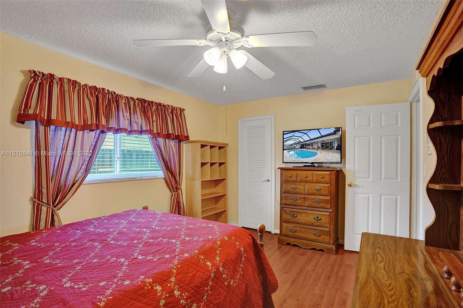 7420 Southwest 15th Street Plantation, FL 33317 - Photo 31 of 60 a bedroom with a bed and a dresser