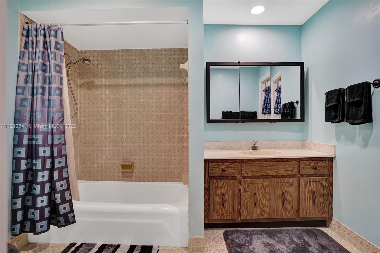 7420 Southwest 15th Street Plantation, FL 33317 - Photo 32 of 60 a bathroom with a sink a large mirror and a bathtub