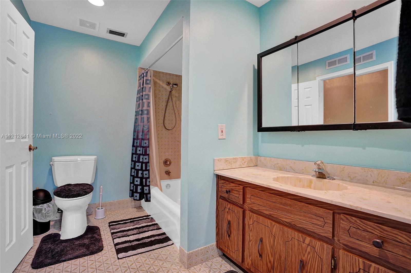 7420 Southwest 15th Street Plantation, FL 33317 - Photo 33 of 60 a bathroom with a sink and a mirror