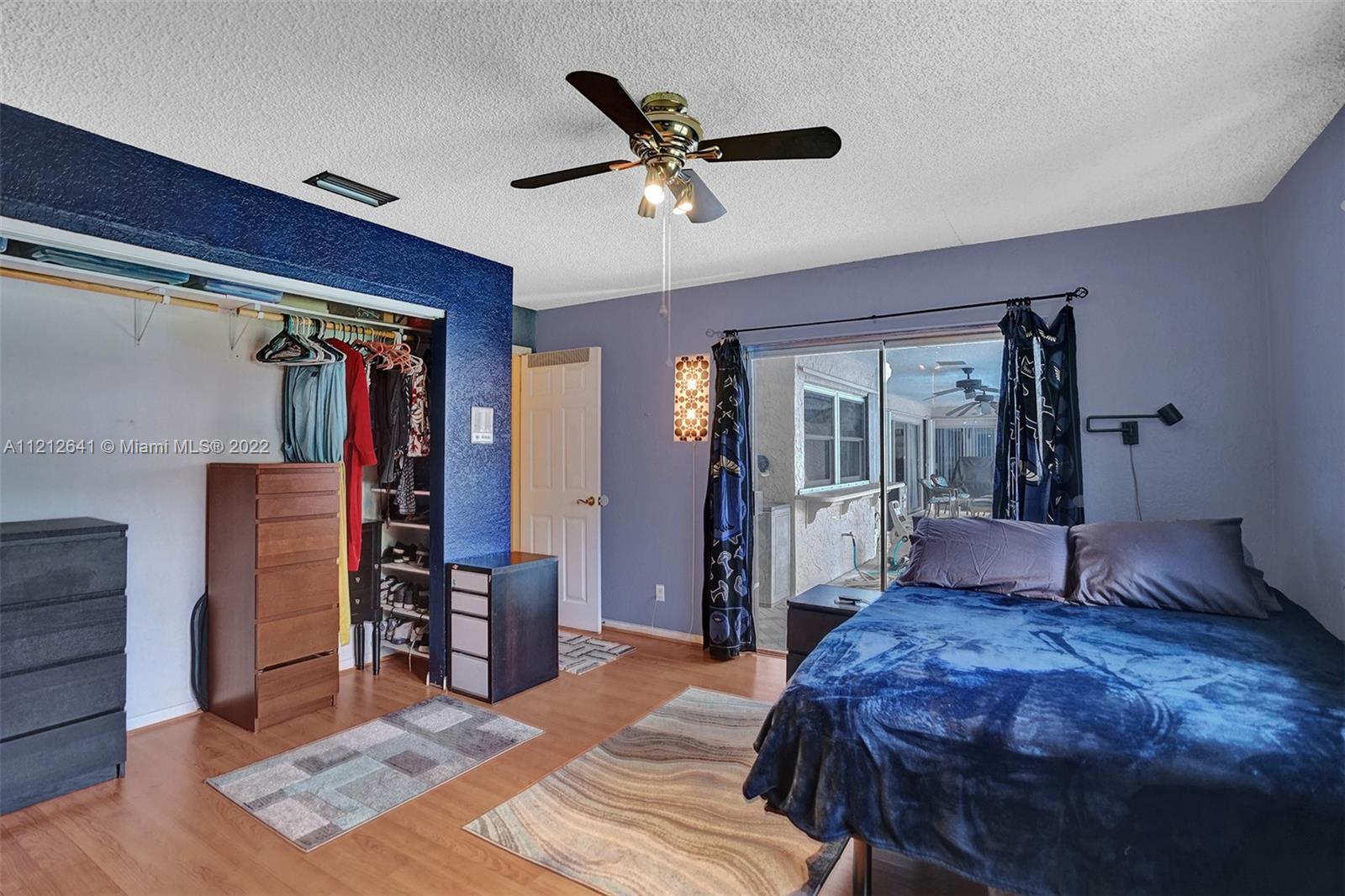 7420 Southwest 15th Street Plantation, FL 33317 - Photo 40 of 60 a bedroom with a bed and a chandelier