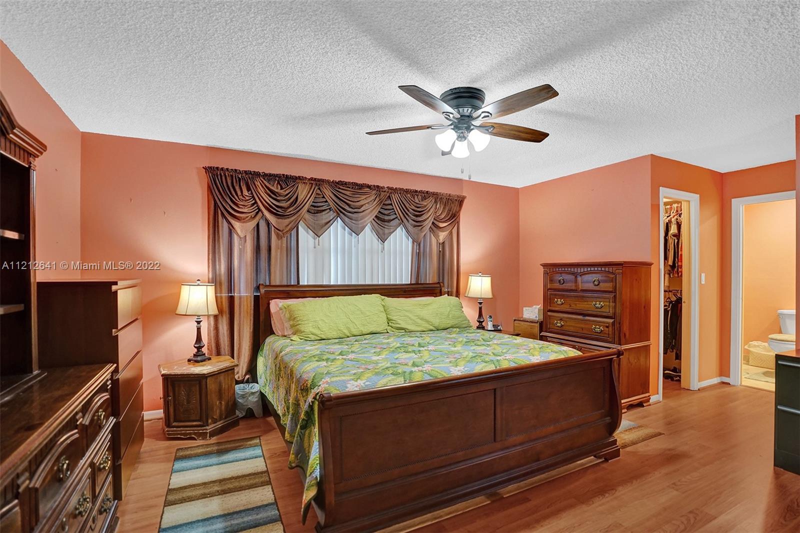 7420 Southwest 15th Street Plantation, FL 33317 - Photo 42 of 60 a bedroom with a bed and a flat screen tv