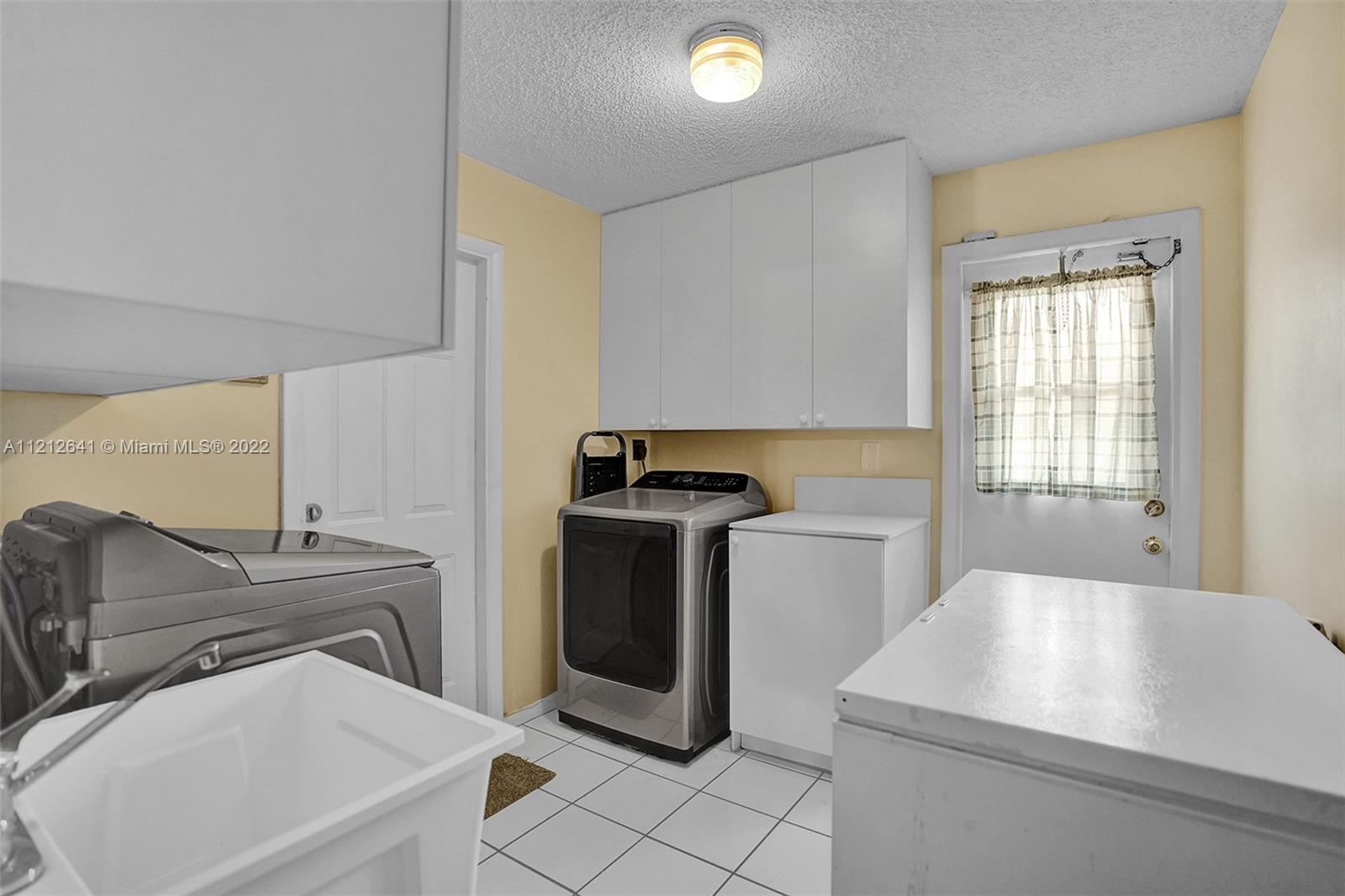7420 Southwest 15th Street Plantation, FL 33317 - Photo 46 of 60 a kitchen with a sink cabinets and appliances