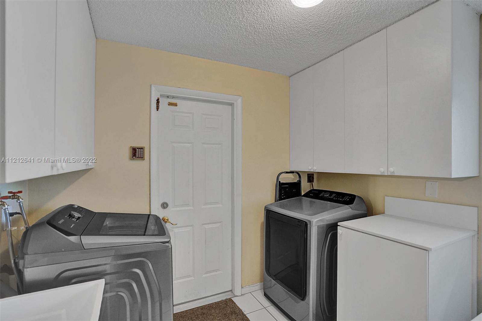 7420 Southwest 15th Street Plantation, FL 33317 - Photo 47 of 60 a utility room with dryer and washer
