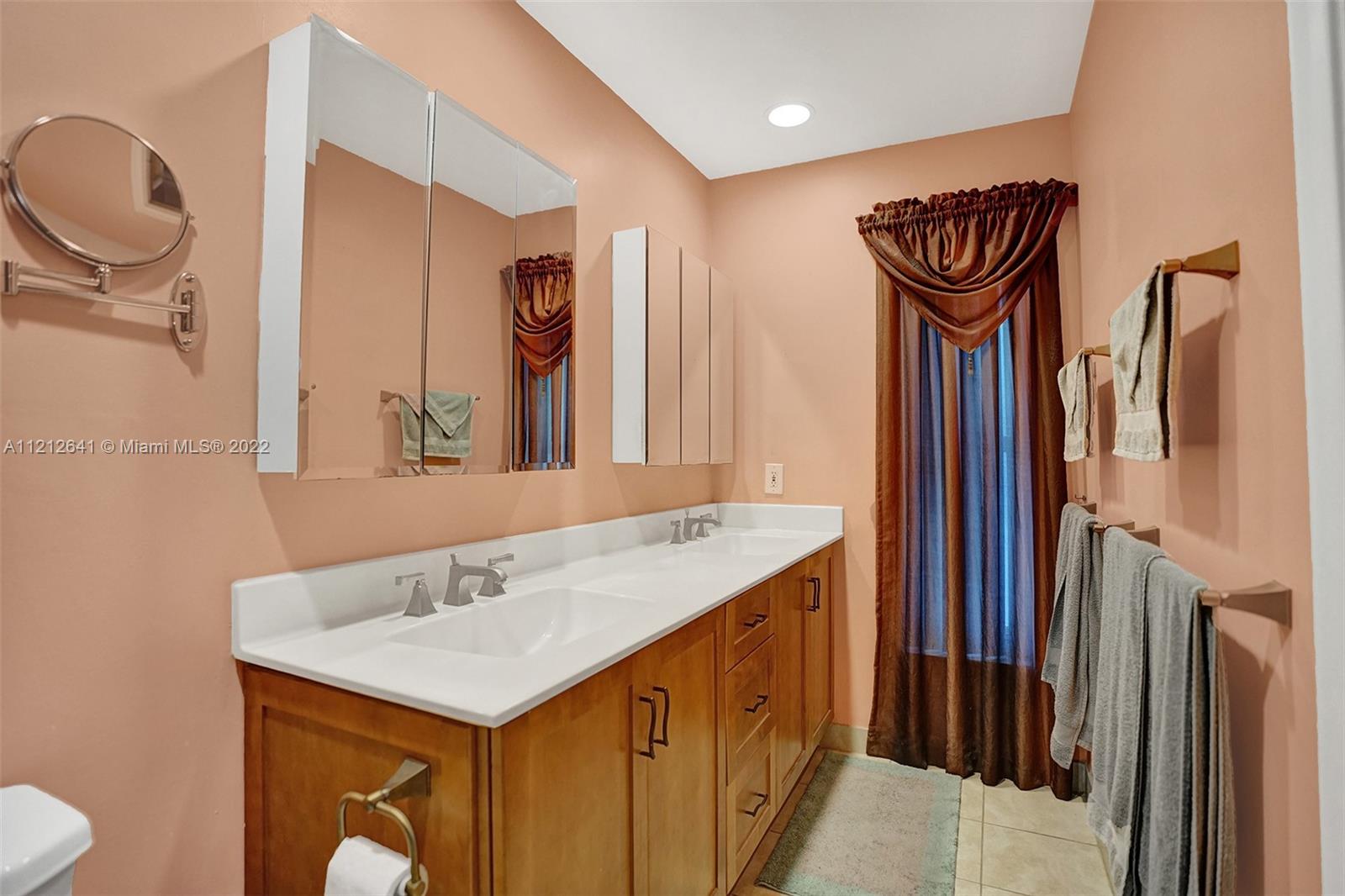 7420 Southwest 15th Street Plantation, FL 33317 - Photo 48 of 60 a bathroom with a sink a mirror and a toilet