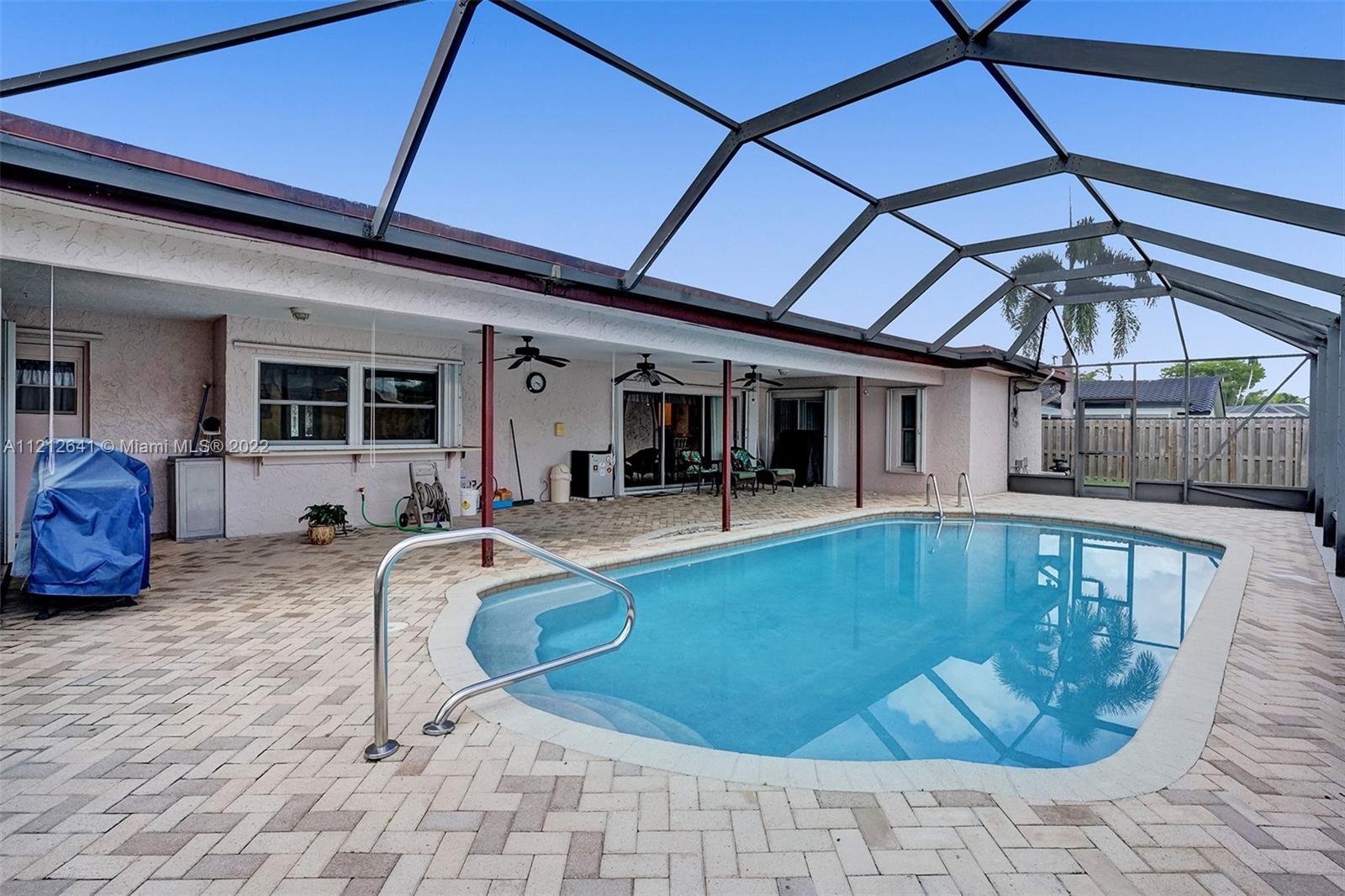7420 Southwest 15th Street Plantation, FL 33317 - Photo 54 of 60 a view of a swimming pool with seating space