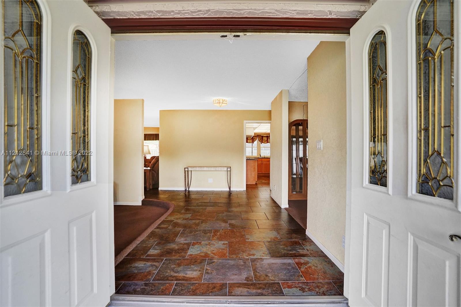 7420 Southwest 15th Street Plantation, FL 33317 - Photo 6 of 60 a view of a hallway with wooden floor and a living room