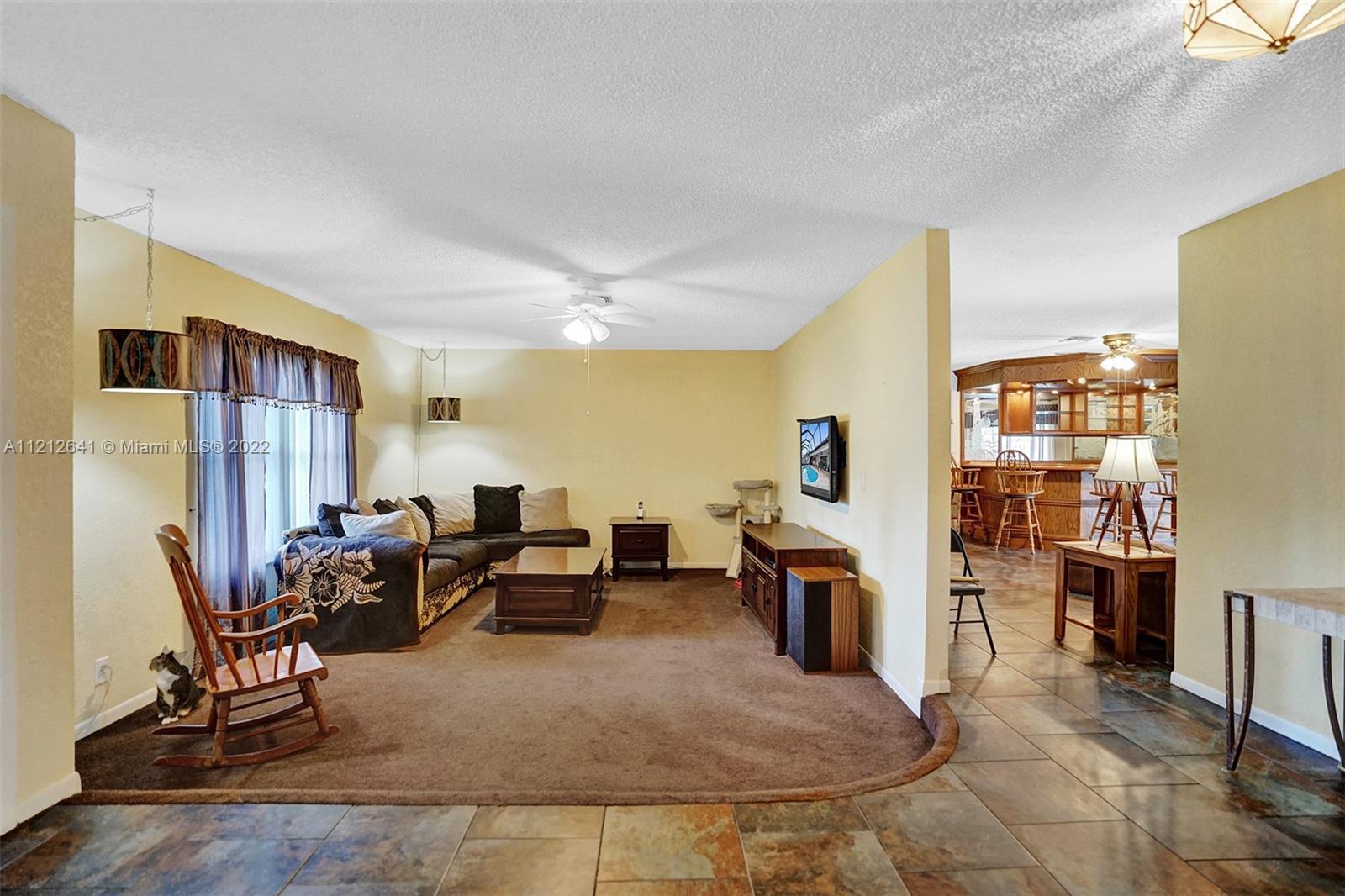 7420 Southwest 15th Street Plantation, FL 33317 - Photo 8 of 60 a living room with furniture and a fireplace