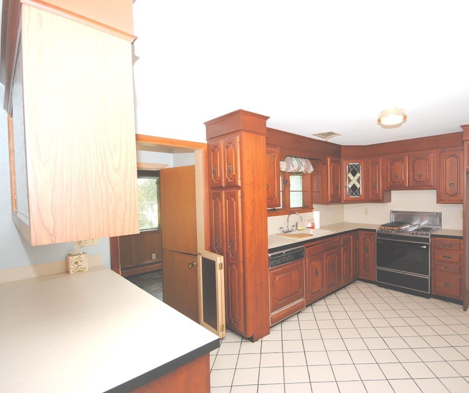 8 Quadrant Road Salem, MA 01970 - Photo 5 of 14 a kitchen with stainless steel appliances granite countertop a refrigerator and a stove top oven