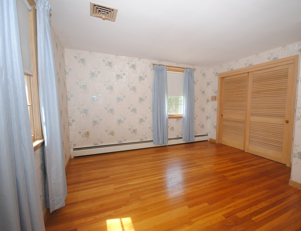 8 Quadrant Road Salem, MA 01970 - Photo 7 of 14 a view of an empty room with wooden floor and a window