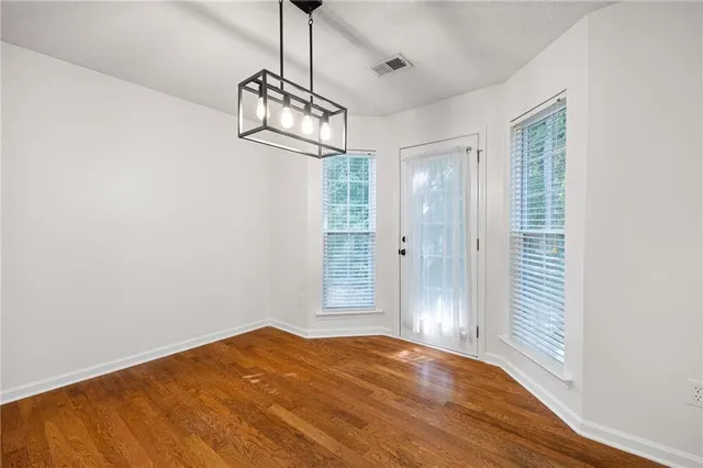 a view of a livingroom with wooden floor and a ceiling fan