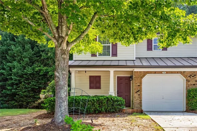 a view of house with tree and front view of a house