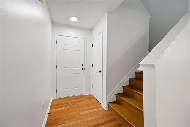 a view of bedroom with wooden floor and stairs