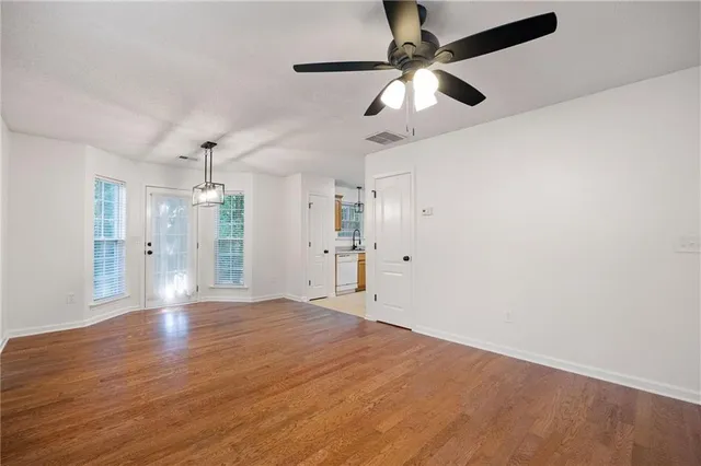 an empty room with fan and a ceiling fan