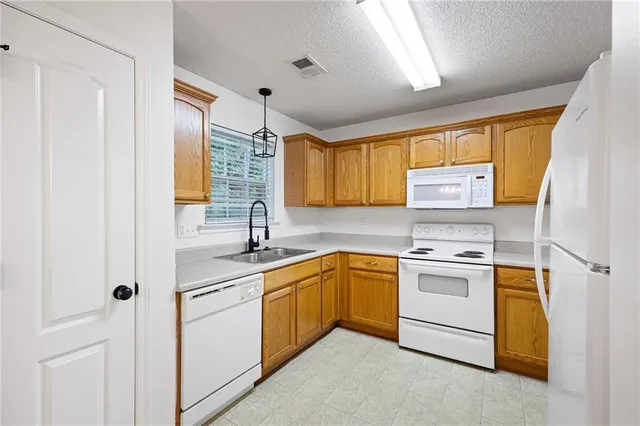 a kitchen with a sink stove and cabinets