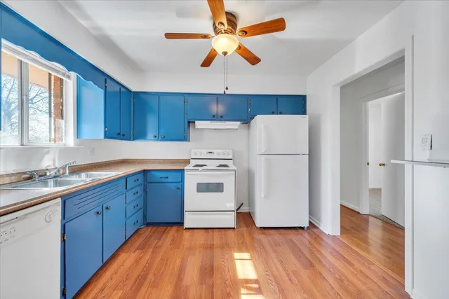 a kitchen with a white cabinets and white appliances
