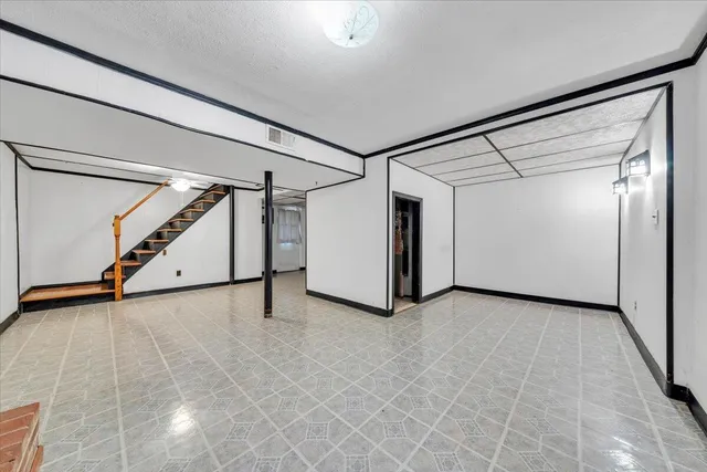 a view of an empty room with stairs