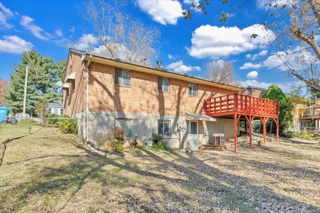 a view of a house with a large tree