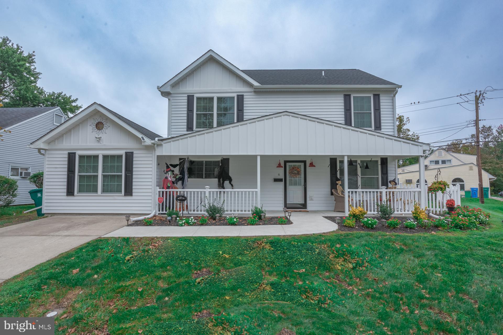a front view of a house with a yard and porch