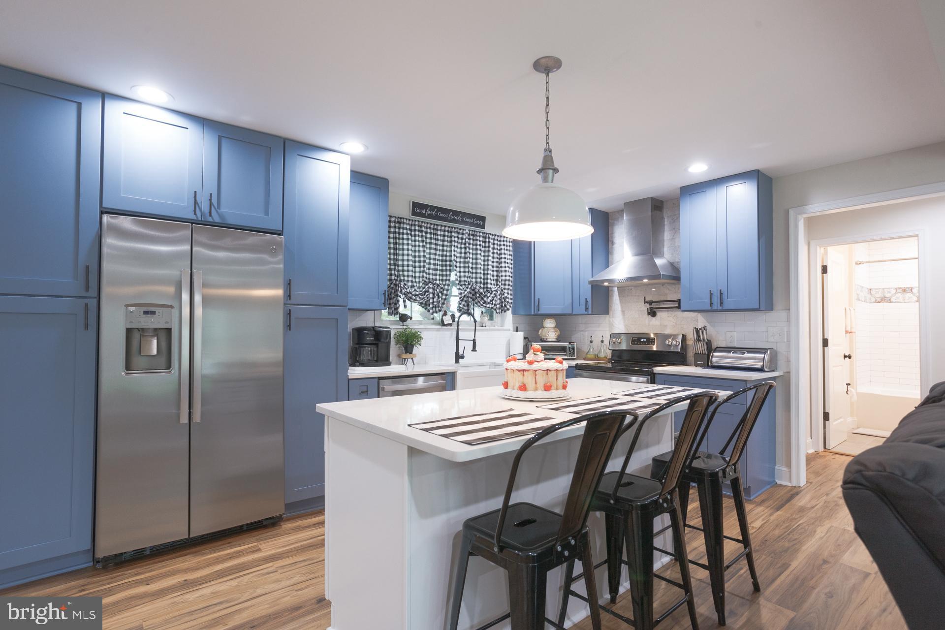 6 Hickory Lane Levittown, PA 19055 - Photo 15 of 32 a kitchen with refrigerator a sink and chairs