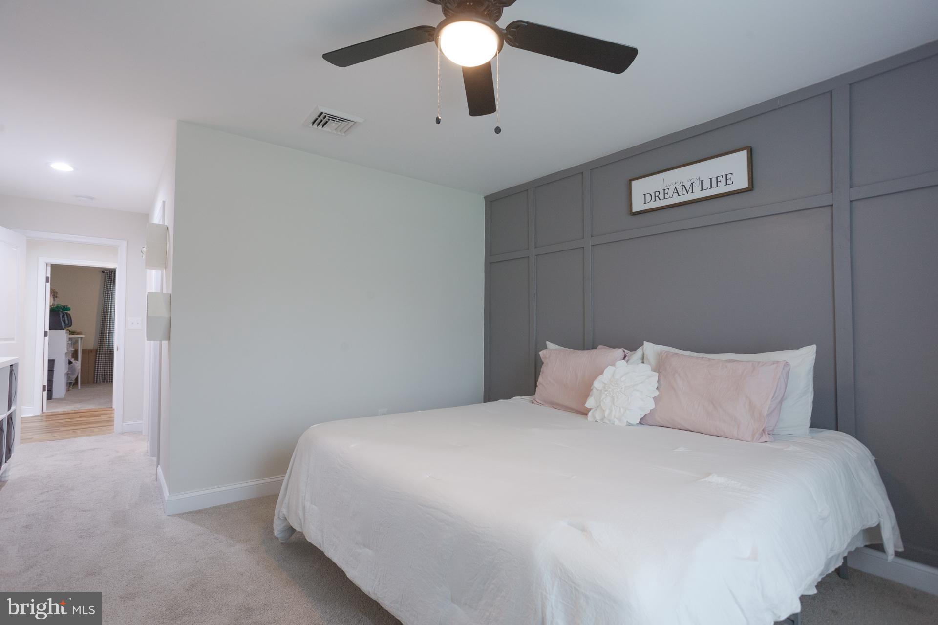 6 Hickory Lane Levittown, PA 19055 - Photo 21 of 32 a bedroom with a bed and a chandelier