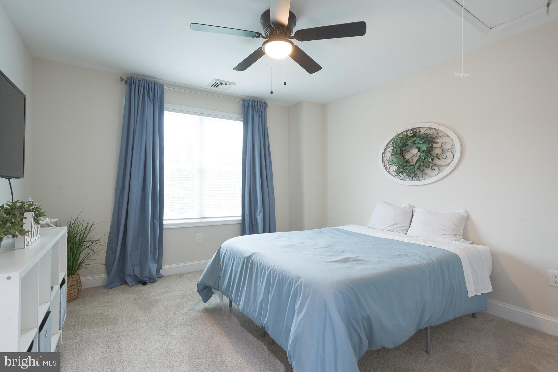 6 Hickory Lane Levittown, PA 19055 - Photo 24 of 32 a bedroom with a bed and a chandelier