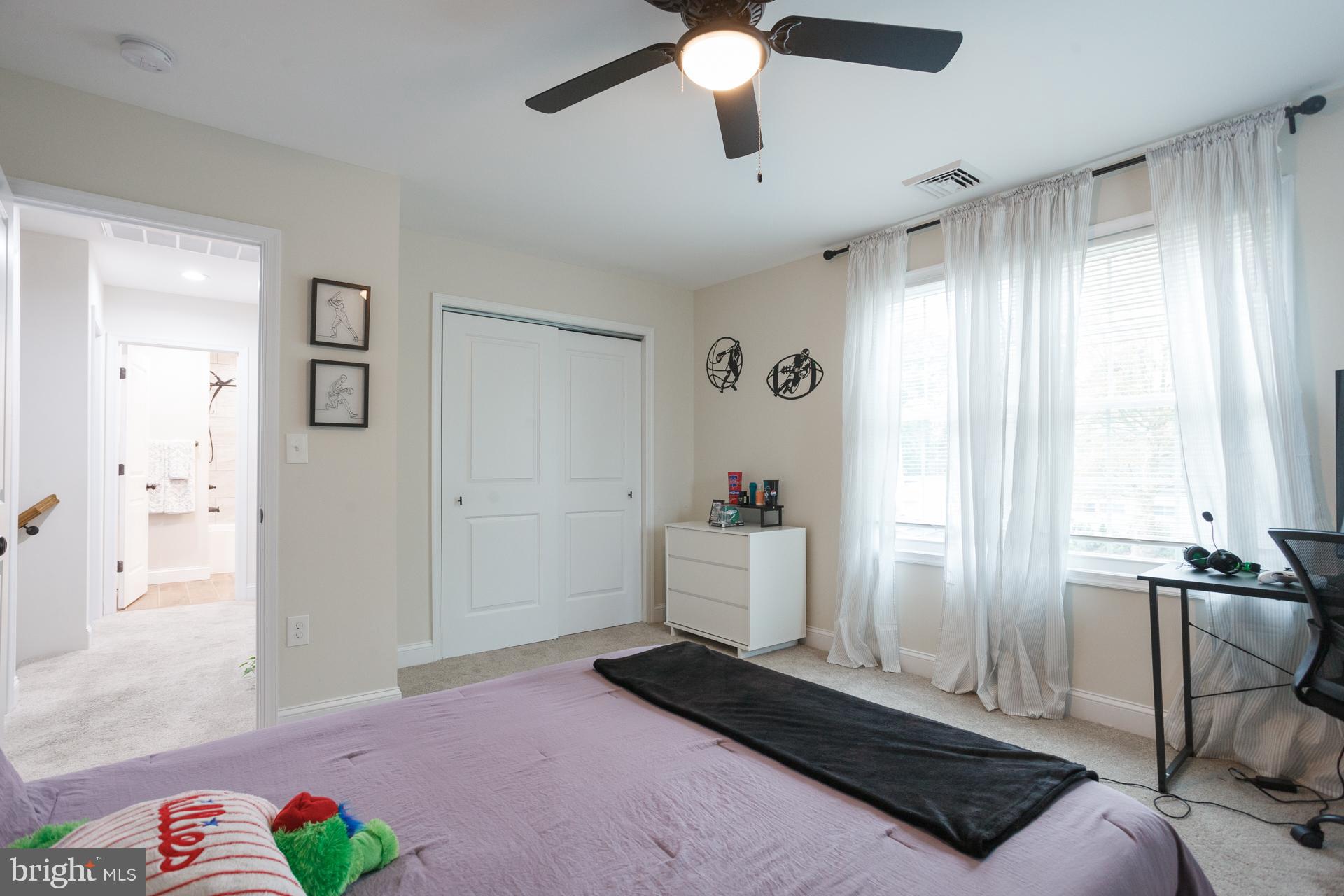 6 Hickory Lane Levittown, PA 19055 - Photo 27 of 32 a bedroom with a bed and a chandelier
