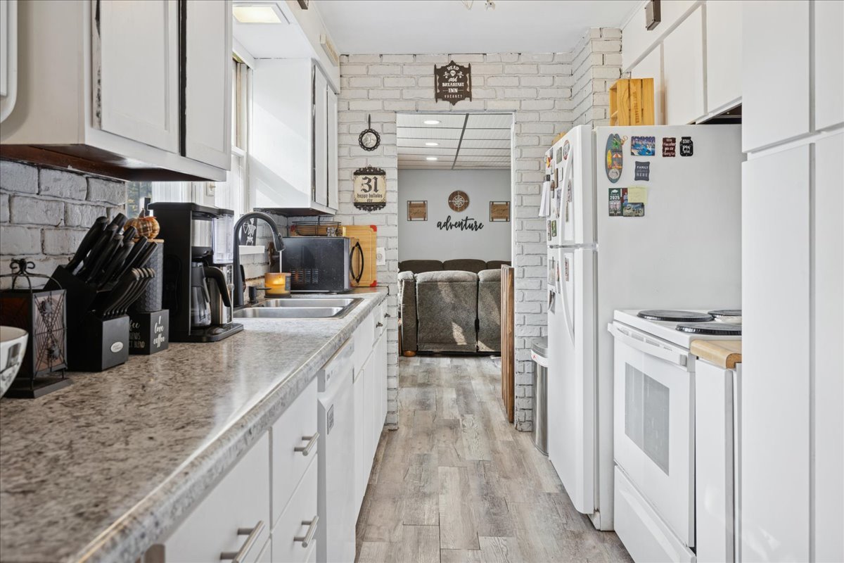 5116 Willow Drive Wonder Lake, IL 60097 - Photo 6 of 15 a kitchen with stainless steel appliances granite countertop a refrigerator and a sink