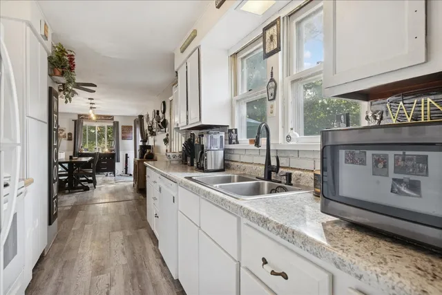 a kitchen with sink and cabinets