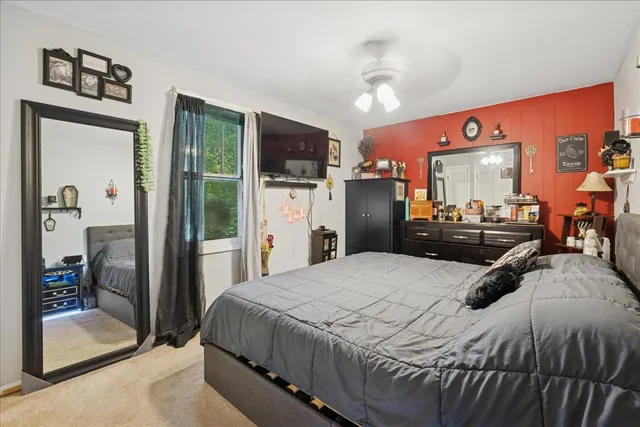 a bedroom with a bed and a large mirror with the outer view