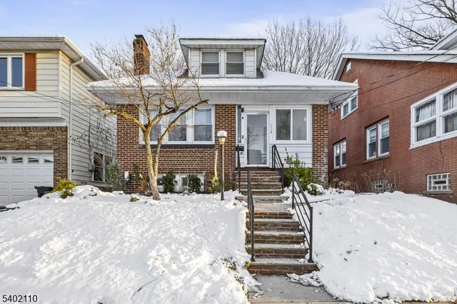 a view of a house with a snow in the yard