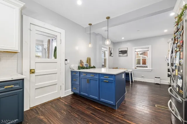 a kitchen with stainless steel appliances granite countertop a stove and a refrigerator