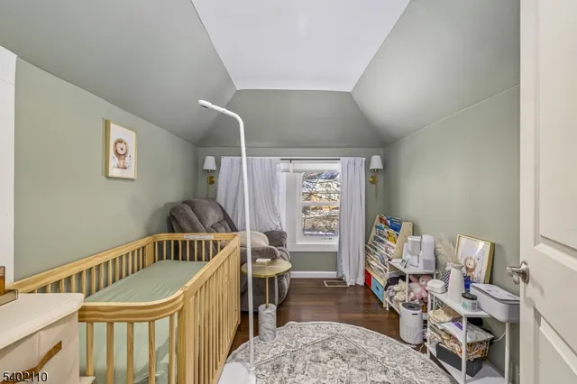 a living room with a table or chairs and a potted plant