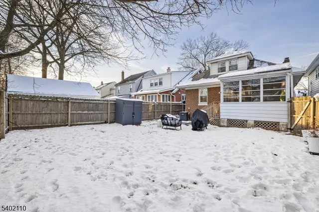 a view of backyard space with wooden fence