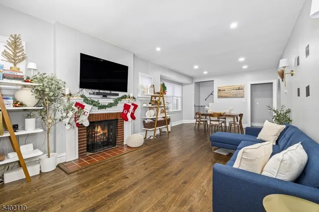 a living room with furniture flat screen tv and a fireplace