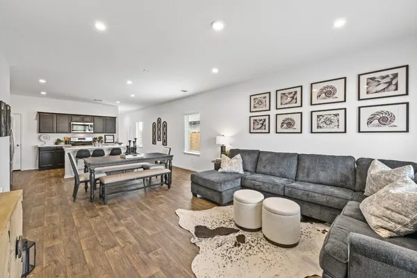 a living room with furniture and wooden floor