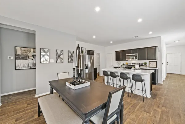 a view of a dining room with furniture and wooden floor