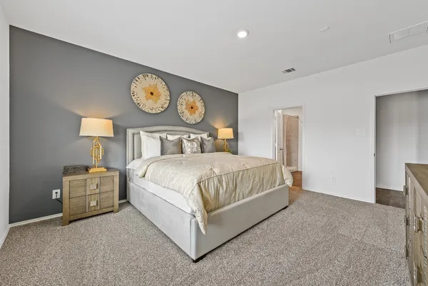 a bedroom with a bed and a clock on the wall