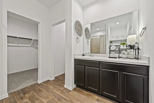 a spacious bathroom with a double vanity sink and a mirror