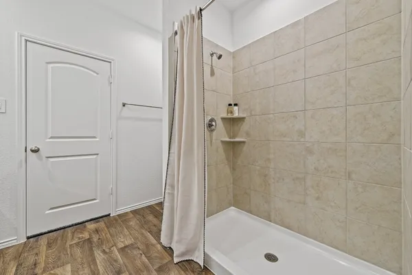 a bathroom with a tub and shower