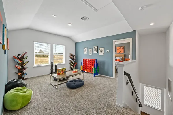 a living room with furniture gym equipment and a window